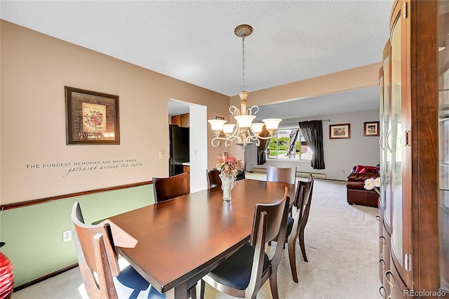 dining space featuring light colored carpet, a baseboard heating unit, a textured ceiling, and a chandelier
