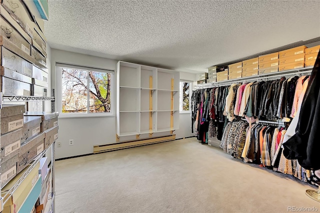 spacious closet featuring a baseboard heating unit and carpet flooring