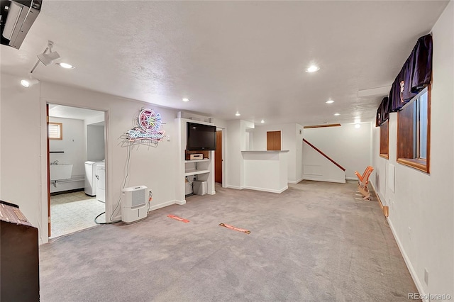 finished basement with recessed lighting, a sink, baseboards, and light carpet