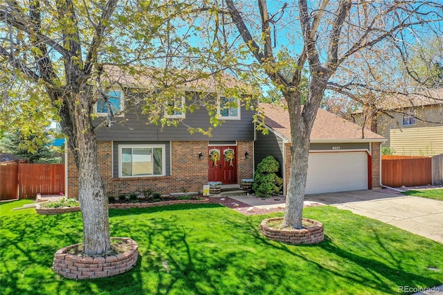 colonial inspired home with a garage, brick siding, fence, a front lawn, and concrete driveway