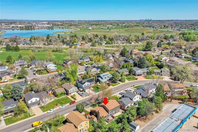 birds eye view of property featuring a water view, view of golf course, and a residential view