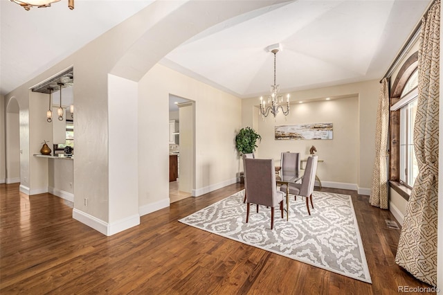 dining room featuring dark hardwood / wood-style floors and a chandelier