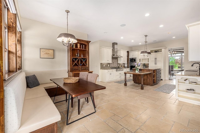 living room with a chandelier, sink, and light tile flooring