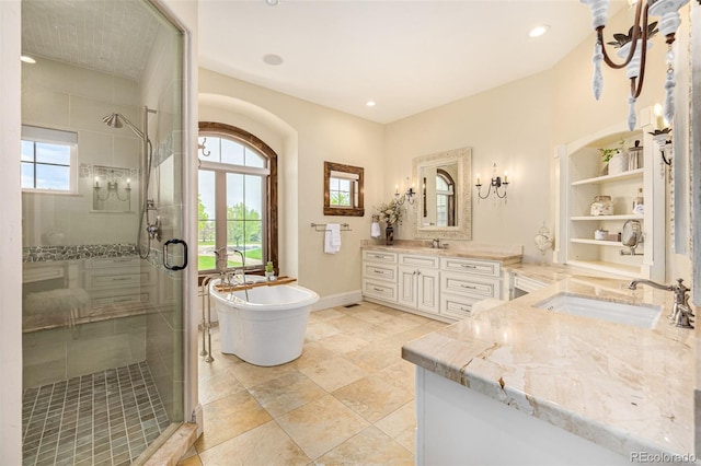 bathroom with tile flooring, vanity, and shower with separate bathtub