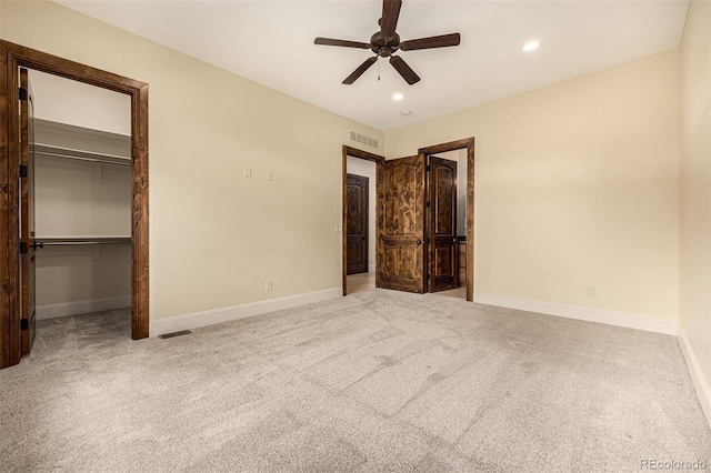 unfurnished bedroom featuring a closet, ceiling fan, and carpet flooring