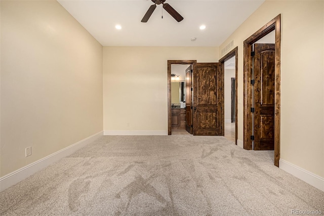 unfurnished bedroom featuring ceiling fan, carpet, and ensuite bath