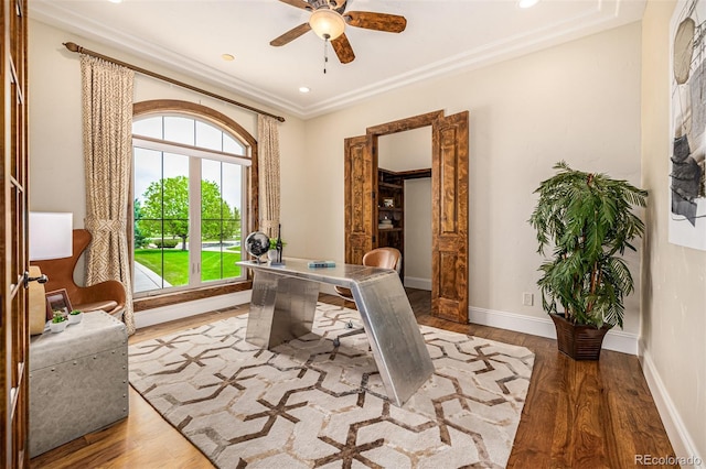 home office featuring hardwood / wood-style flooring, ornamental molding, and ceiling fan