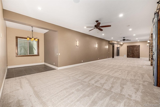 spare room featuring ceiling fan and dark colored carpet