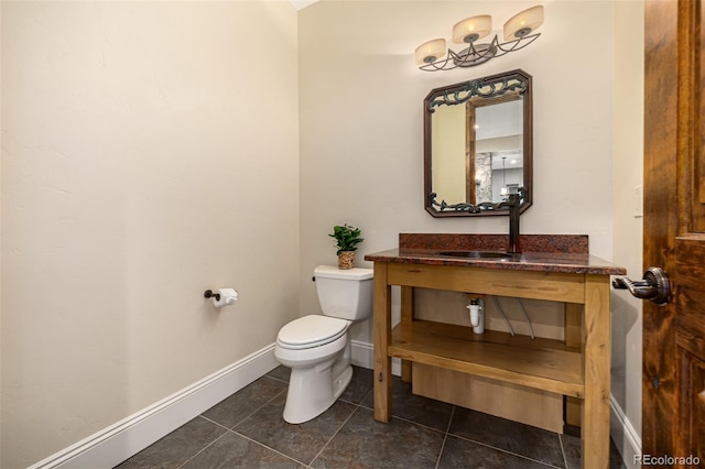 bathroom with vanity, toilet, and tile flooring