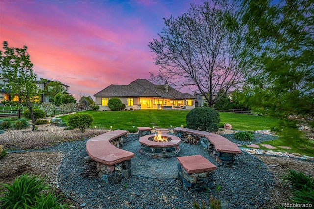 yard at dusk featuring a fire pit