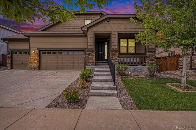 craftsman house featuring covered porch and a garage