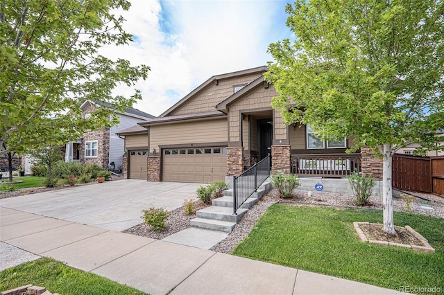 craftsman inspired home with a garage and a front lawn