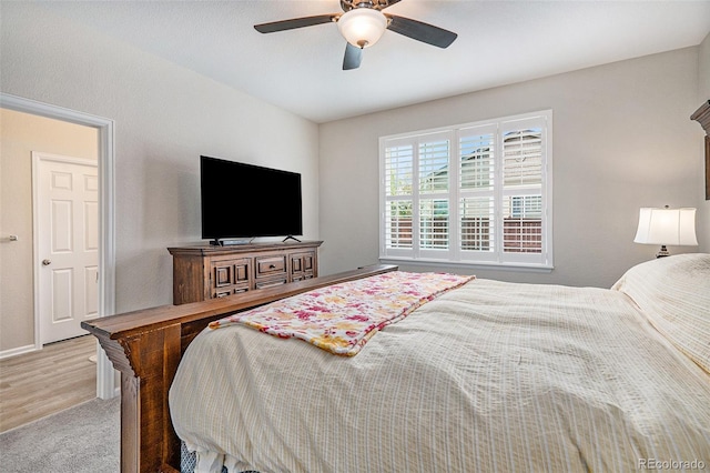 bedroom with ceiling fan and hardwood / wood-style flooring