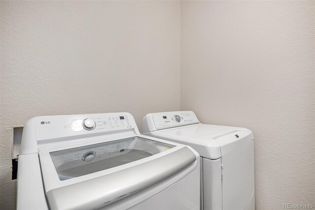 clothes washing area featuring washing machine and clothes dryer