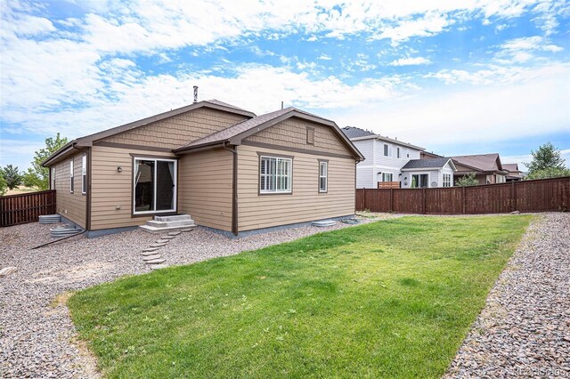 back of house with a yard and a patio area