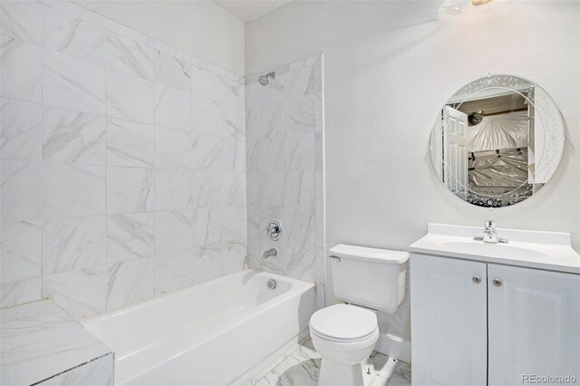 full bathroom featuring tile patterned floors, tiled shower / bath combo, vanity, and toilet