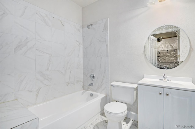 full bathroom with tiled shower / bath, vanity, and toilet