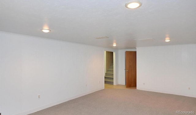 basement featuring light colored carpet