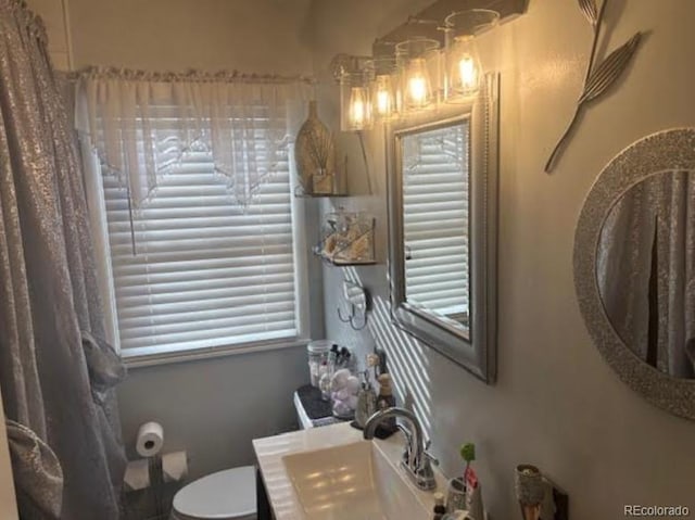 bathroom with toilet and vanity