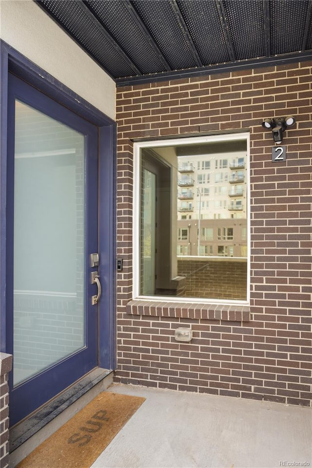 property entrance with brick siding