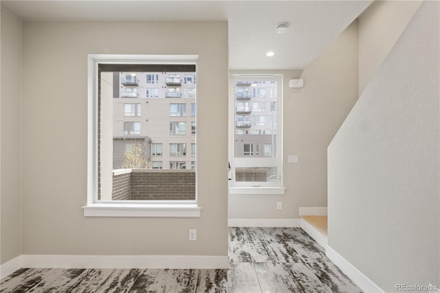interior space with baseboards and recessed lighting