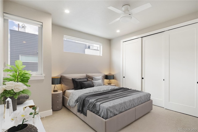 bedroom with a ceiling fan, a closet, light carpet, baseboards, and recessed lighting