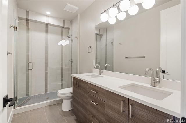 full bathroom with toilet, a stall shower, and a sink