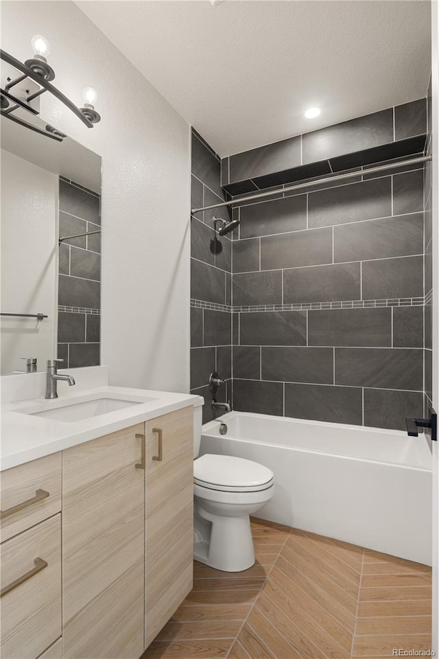 full bathroom with toilet, vanity, and shower / bath combination