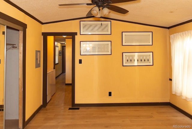 empty room with a textured ceiling, light hardwood / wood-style flooring, ceiling fan, and ornamental molding