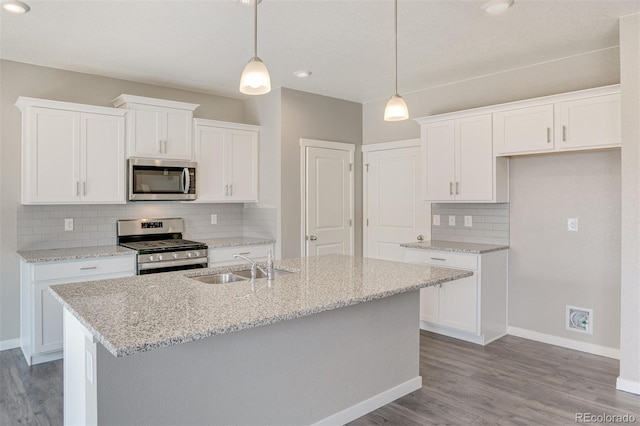 13466 Valentia St, Thornton, CO 80602 - kitchen with stainless steel appliances, a sink, baseboards, white cabinets, and recessed lighting