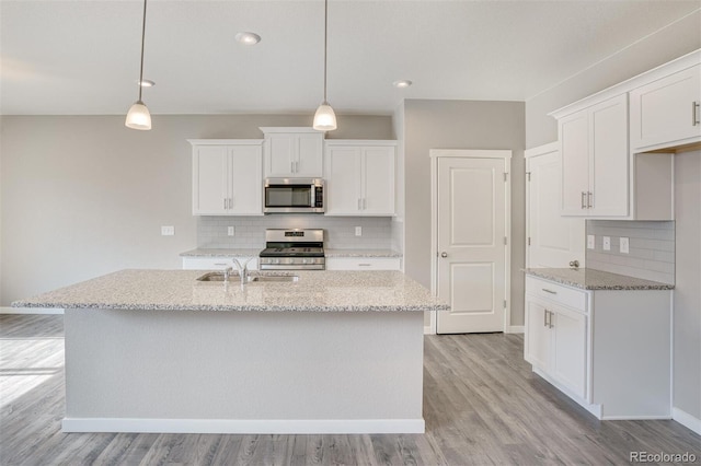 13466 Valentia St, Thornton, CO 80602 - kitchen with appliances with stainless steel finishes, backsplash, a sink, light wood-type flooring, and recessed lighting