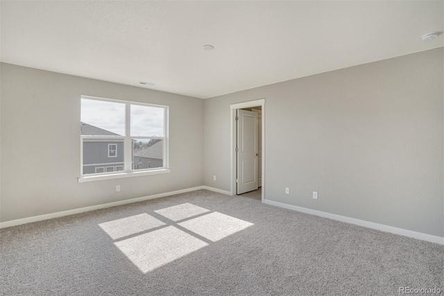 13466 Valentia St, Thornton, CO 80602 - empty room featuring light carpet, baseboards, and a smoke detector