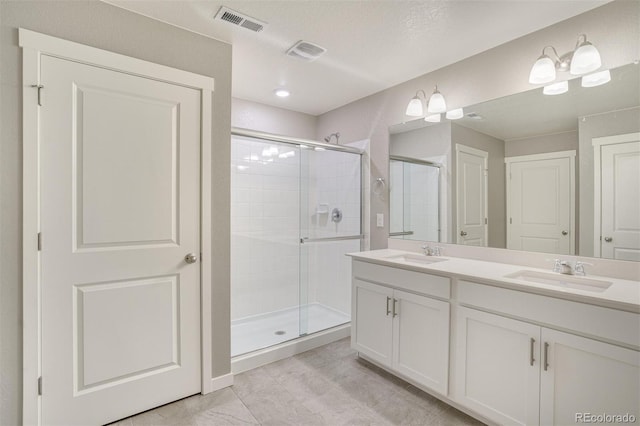 13466 Valentia St, Thornton, CO 80602 - bathroom with a shower stall, double vanity, and tile patterned floors