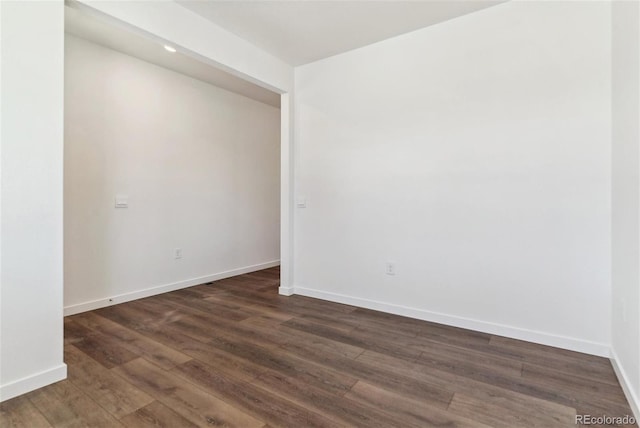 empty room featuring dark hardwood / wood-style flooring