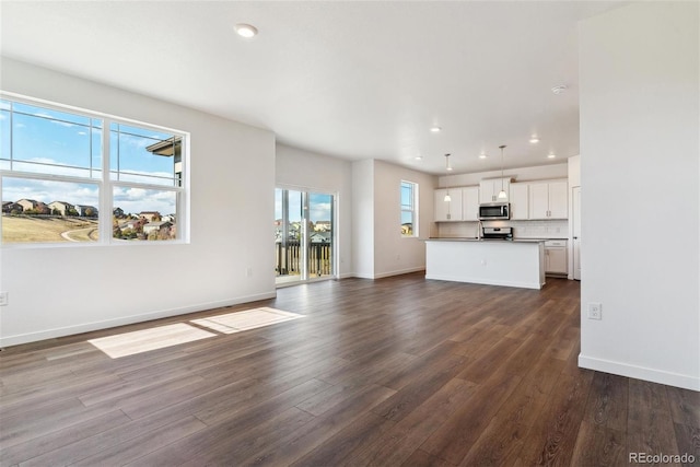 unfurnished living room featuring dark wood-type flooring