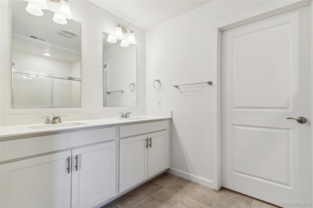 bathroom with a shower with shower door and vanity