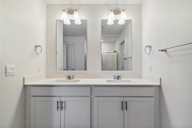 bathroom with vanity and a shower with shower door