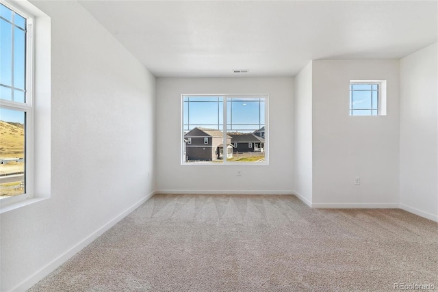 empty room featuring light colored carpet