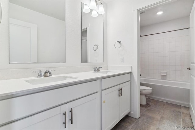 full bathroom with toilet, tiled shower / bath combo, and vanity