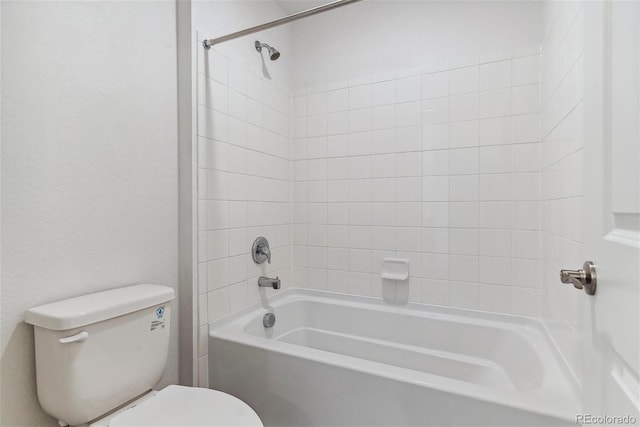 bathroom with toilet and tiled shower / bath combo