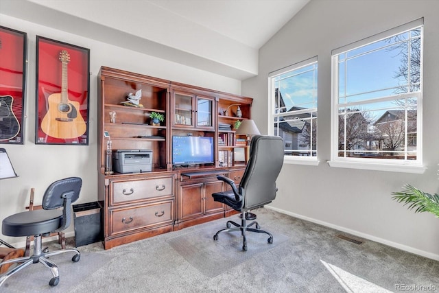 carpeted home office featuring lofted ceiling, visible vents, and baseboards