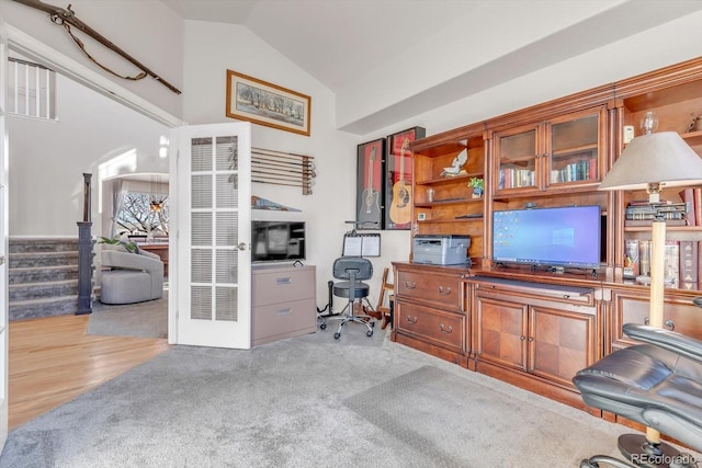 office area with carpet floors and vaulted ceiling