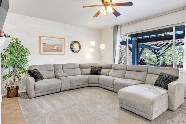 living area with ceiling fan and plenty of natural light