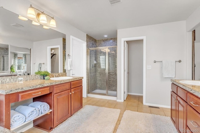 bathroom featuring a shower stall, vanity, visible vents, and tile patterned floors