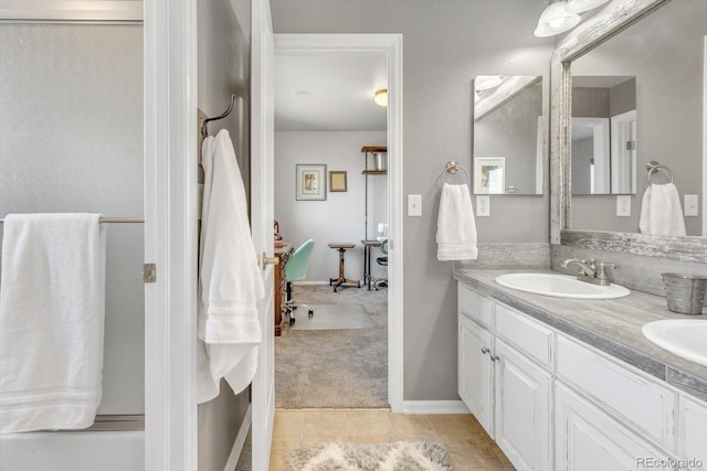 bathroom featuring double vanity, tile patterned flooring, and a sink