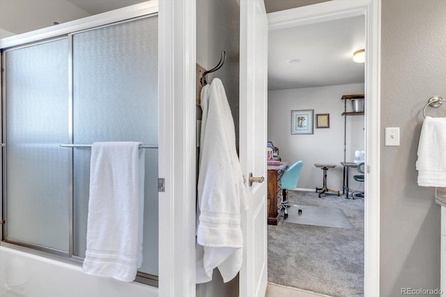 full bath featuring bath / shower combo with glass door