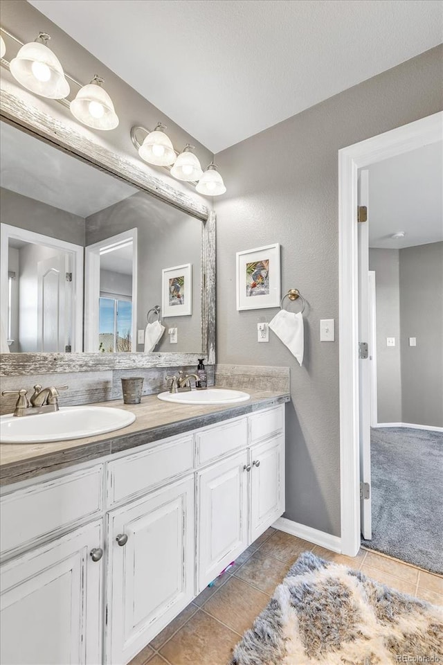 full bathroom featuring tile patterned flooring, a sink, and double vanity