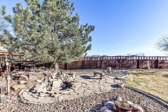 view of yard with an outdoor fire pit, a patio area, and a fenced backyard