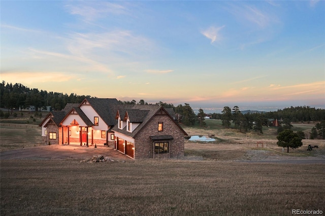 view of front of house with a garage and a lawn