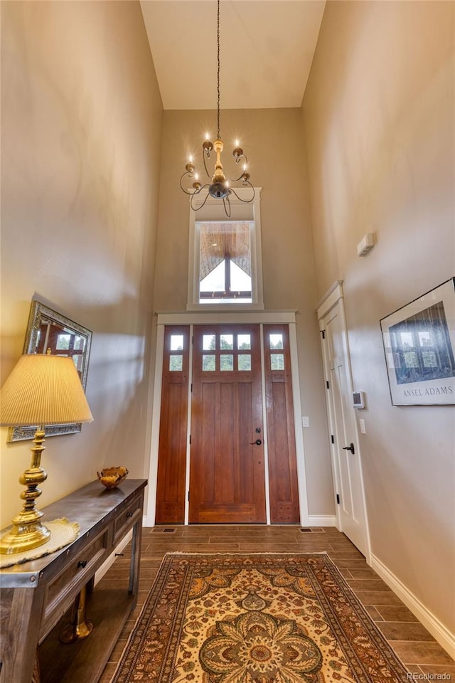 foyer entrance with a high ceiling and an inviting chandelier